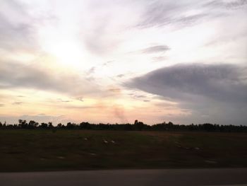 Scenic view of field against sky during sunset