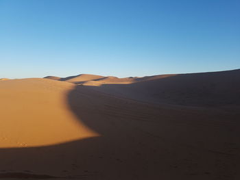 Scenic view of desert against clear sky