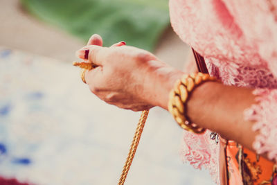 Close-up midsection of woman holding rope
