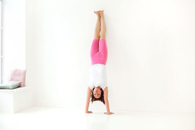 Midsection of woman standing against wall