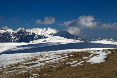 Scenic view of snowcapped mountains against sky