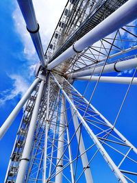 Low angle view of ferris wheel against blue sky