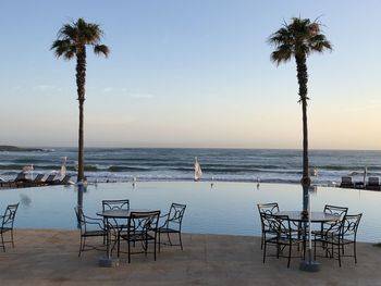 Scenic view of swimming pool by sea against sky
