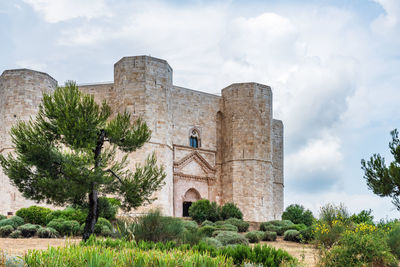 Low angle view of historical building against cloudy sky