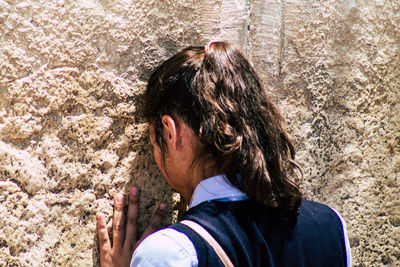 Rear view of woman against wall