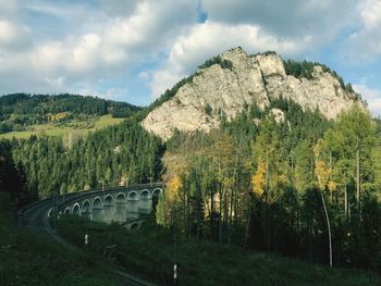 Panoramic view of bridge and mountains against sky