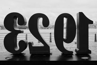 Information sign against sky