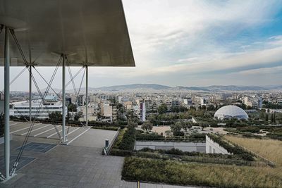 High angle view of buildings against cloudy sky