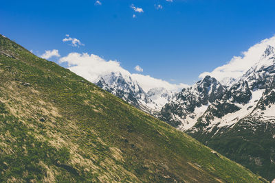 Scenic view of mountains against blue sky