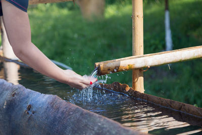 Cropped image of woman with hands cupped under water