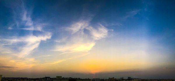 Scenic view of sky over city during sunset