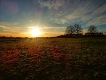 Scenic view of field against sky during sunset