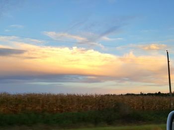 Scenic view of field against sky during sunset