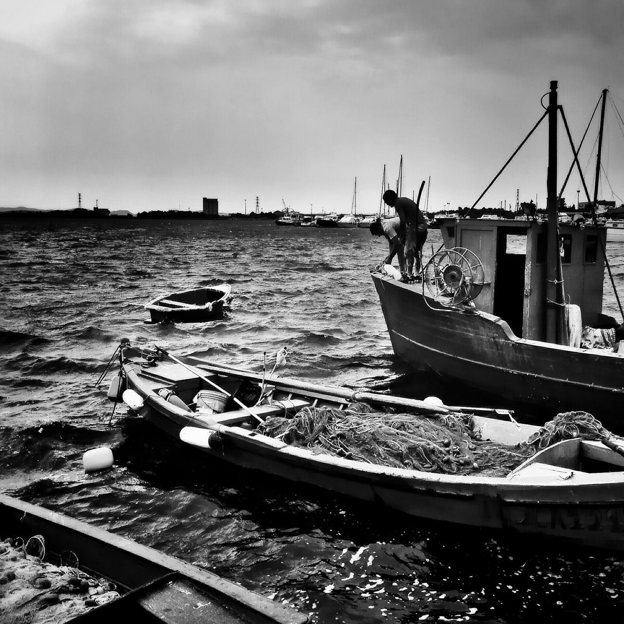 nautical vessel, boat, transportation, water, moored, mode of transport, sky, sea, harbor, cloud - sky, travel, fishing boat, rippled, built structure, outdoors, day, cloud, pier, ship, nature