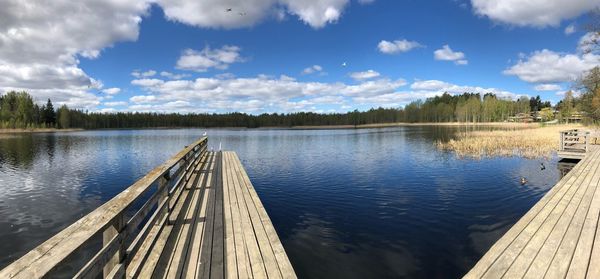 Pier over lake against sky