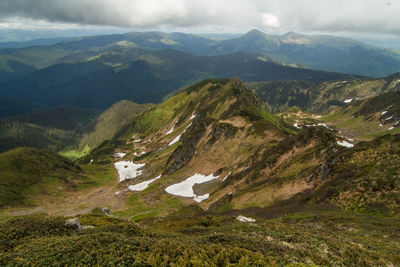 Remaining snow beside mountain ridges landscape photo