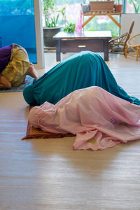 Cute girls in hijab praying at home