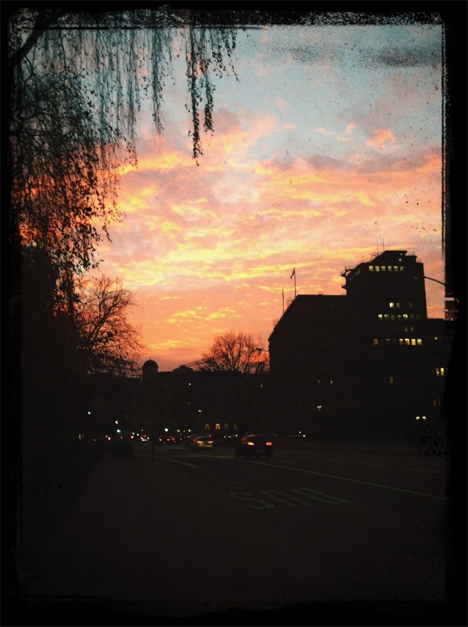 sunset, building exterior, architecture, built structure, sky, city, transfer print, silhouette, orange color, tree, cloud - sky, auto post production filter, car, residential building, street, dusk, building, residential structure, road, transportation