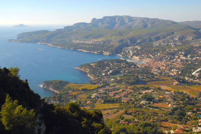 High angle view of townscape by sea against sky