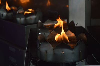 Close-up of lit candles in building at home