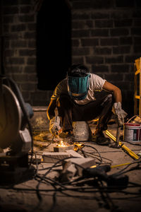 Man wearing mask against wall