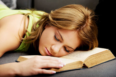 Portrait of young woman reading book