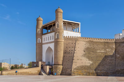 Low angle view of historic building against clear blue sky