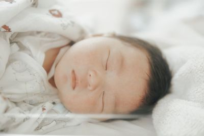 Cute baby sleeping on bed