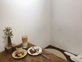 Tea cup on table against wall