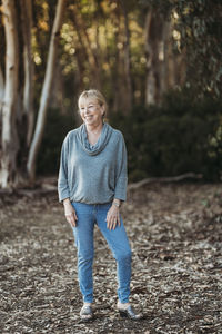 Portrait of senior adult woman smiling in forest