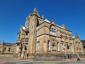 Low angle view of building against clear blue sky