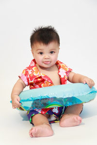 Portrait of cute baby against white background