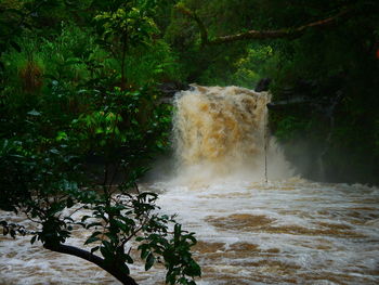 Scenic view of waterfall in sea