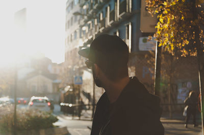 Close-up of man with umbrella in city