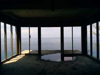 Scenic view of sea against sky seen through window