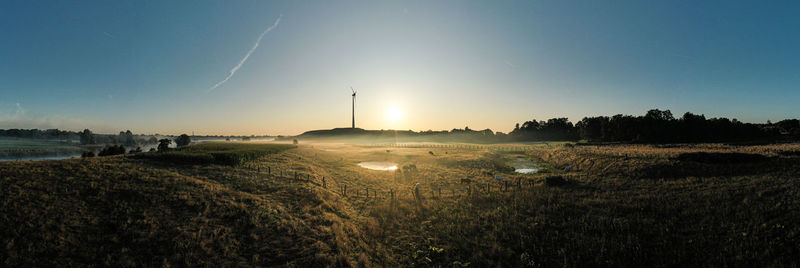 Scenic view of field against sky during sunset