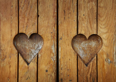 Full frame shot of old wooden door with hearts