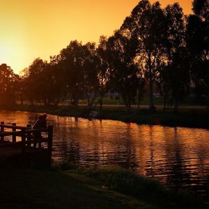 Scenic view of river at sunset