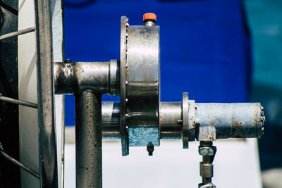 Close-up of metal pipe against blue sky