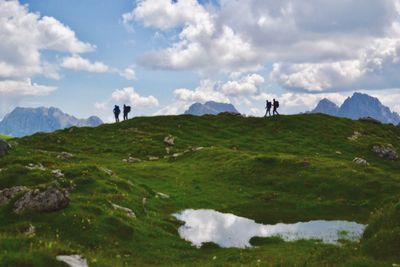 People standing on landscape against sky