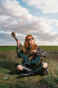 Young woman sitting on field