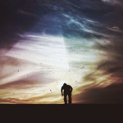 Silhouette of woman at sunset