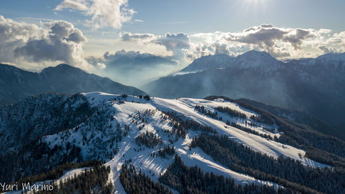 Aerial view of snowcapped mountains against sky