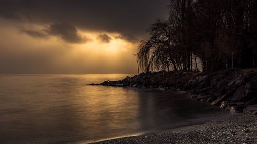 Scenic view of sea against sky at sunset