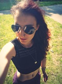 Portrait of man wearing sunglasses standing on field