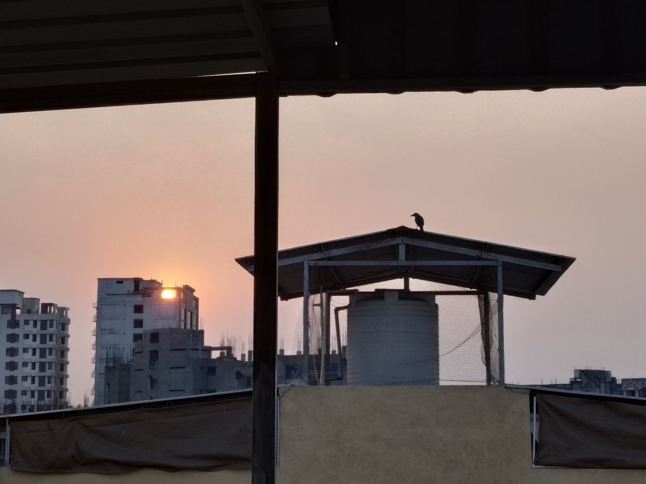 BUILDING AGAINST SKY AT SUNSET