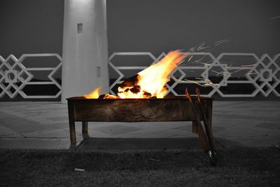 Close-up of fire in the dark against clear sky