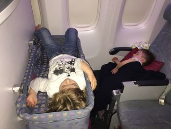 Siblings sleeping in airplane