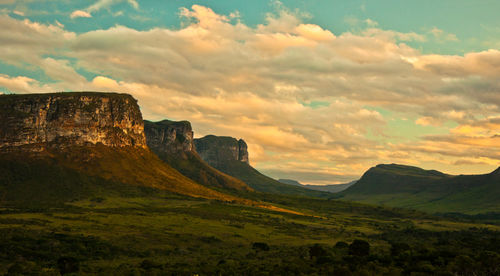 Scenic view of mountains against cloudy sky