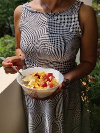 Midsection of woman holding ice cream